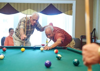 A group of residents shooting pool at Park Place of Elmhurst