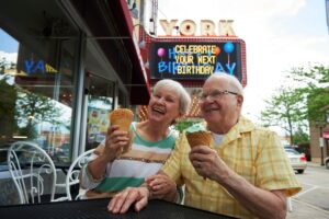 Resident couple enjoying ice cream at a shop near Park Place of Elmhurst