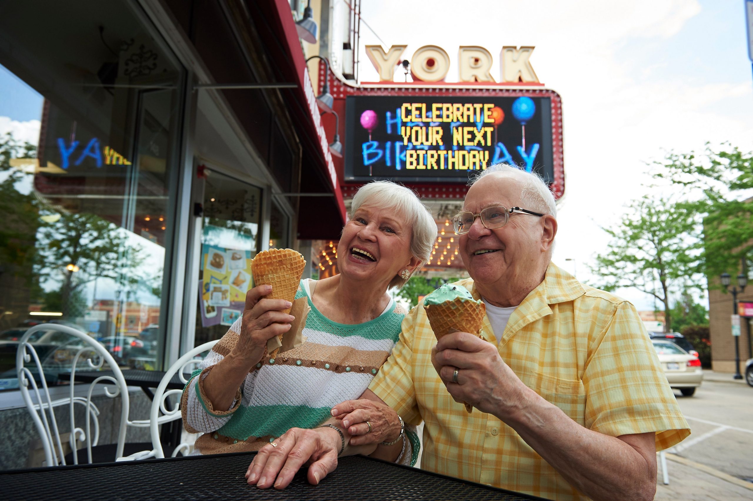 Resident couple enjoying ice cream at a shop near Park Place of Elmhurst 