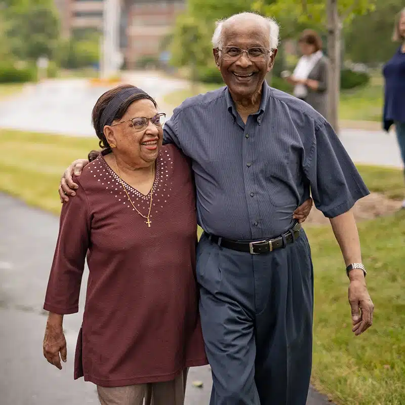 Senior couple walking on campus