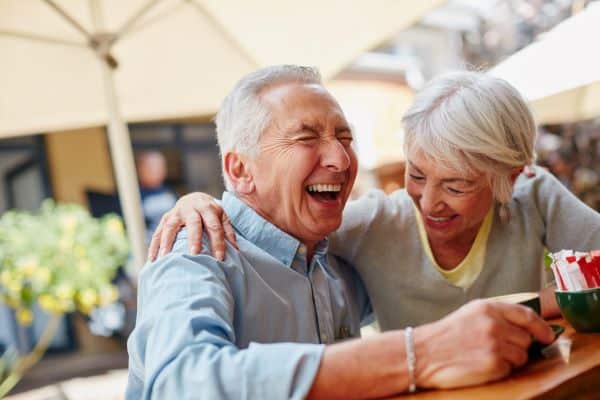 man and woman laughing at table