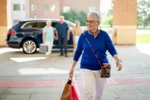 Woman walking into front entrance of Park Place of Elmhurst