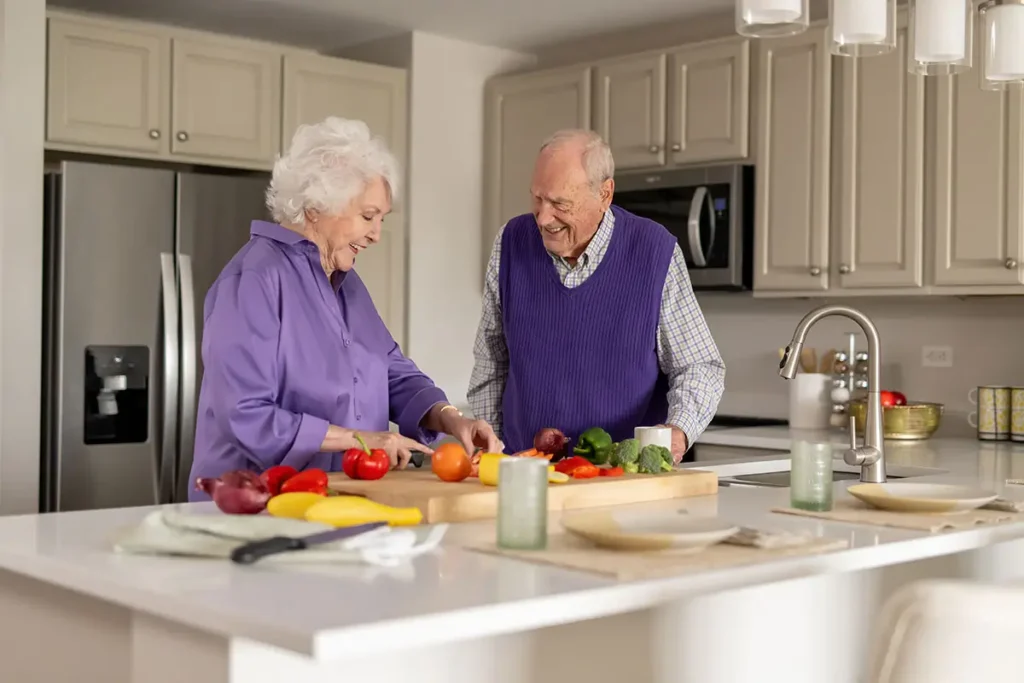 A couple prepares vegetables in the kitchen